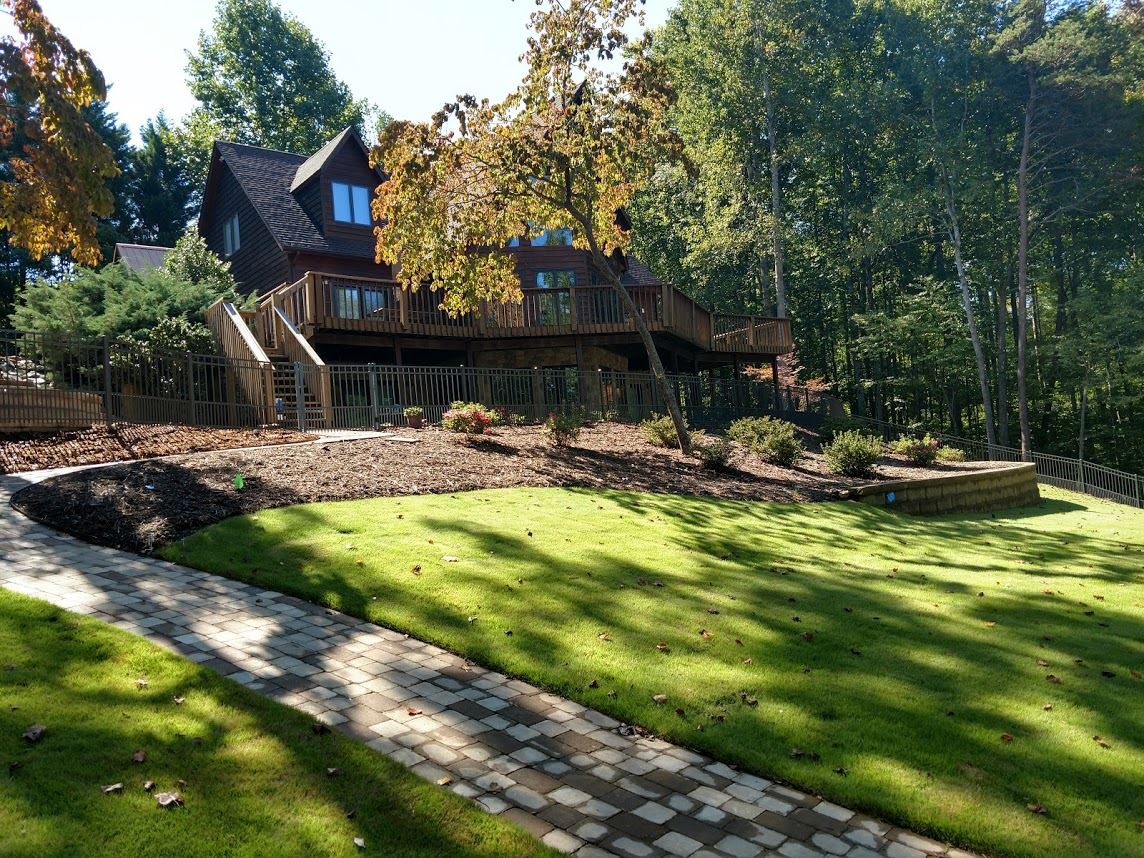 Aluminum fencing enclosing house on a hill