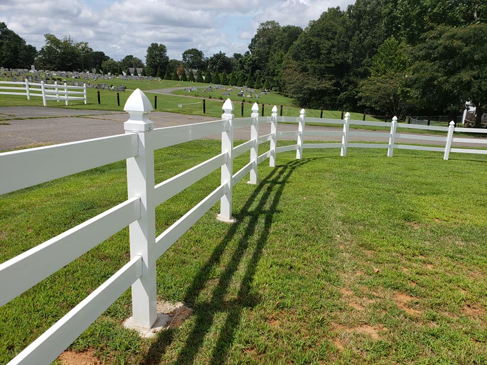 white vinyl picket fence in cemetery