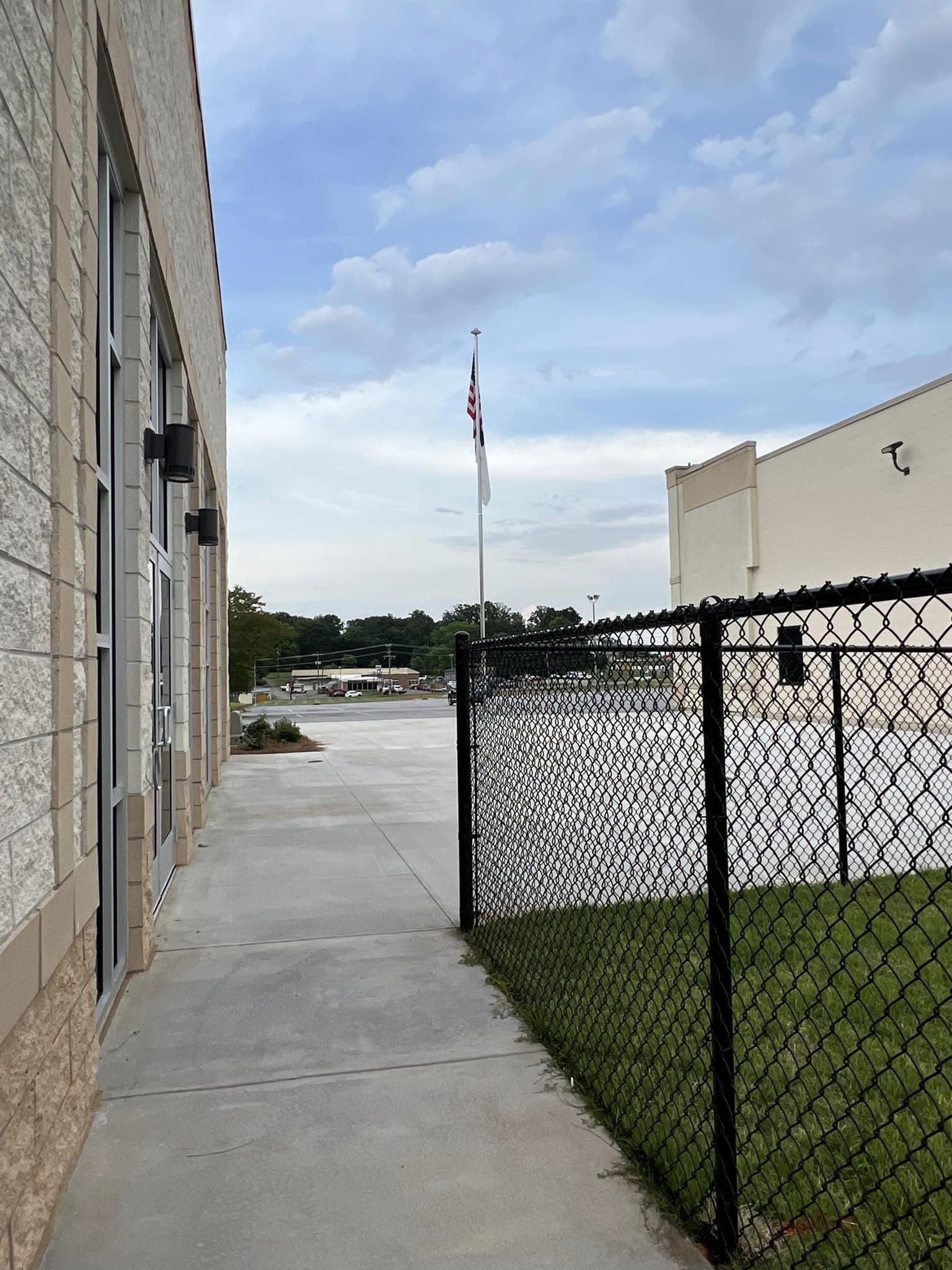 Black vinyl-coated chain link fencing surrounding commercial property