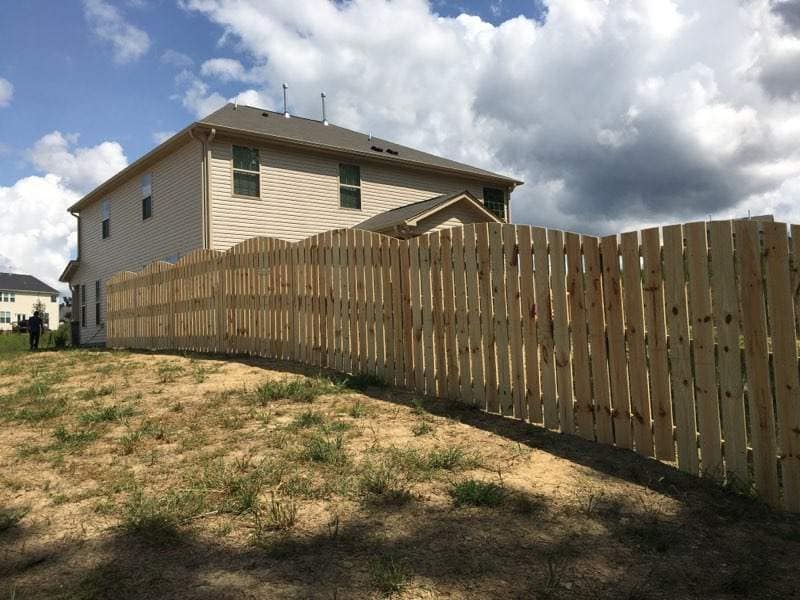 wood fence with scalloped design