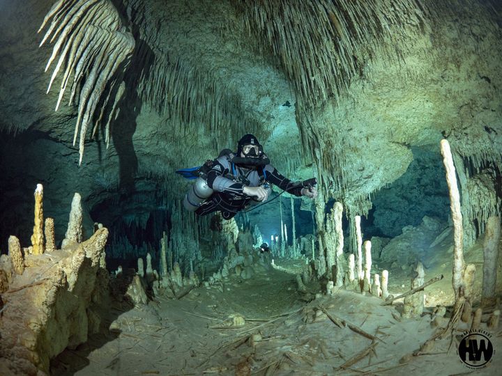 Scuba divers explore underwater caves