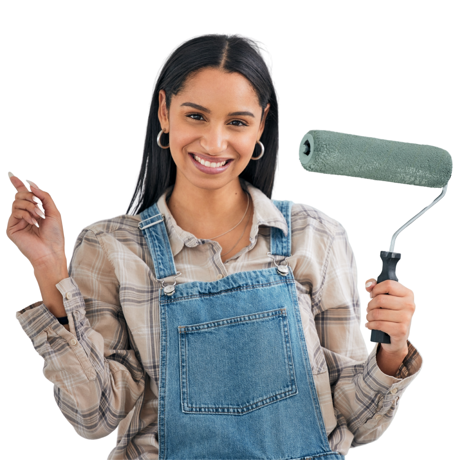 A woman in overalls is holding a paint roller and smiling.