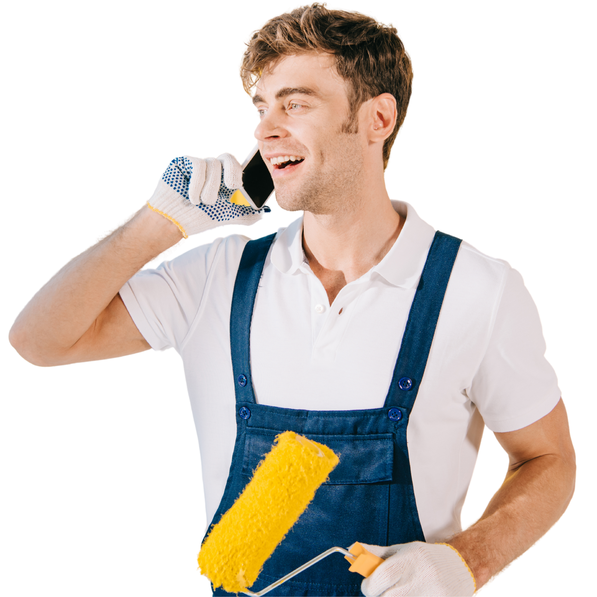 A man is holding a paint roller and talking on a cell phone