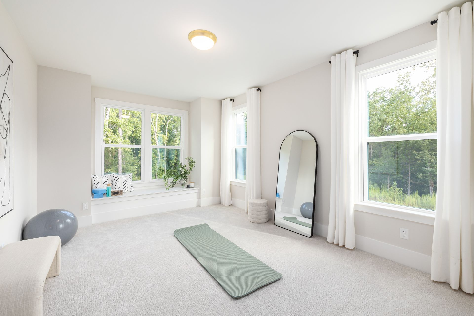 There is a yoga mat in the middle of the room.