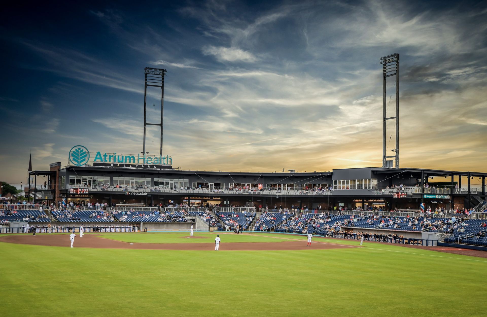 A baseball stadium with a lot of people watching a game.