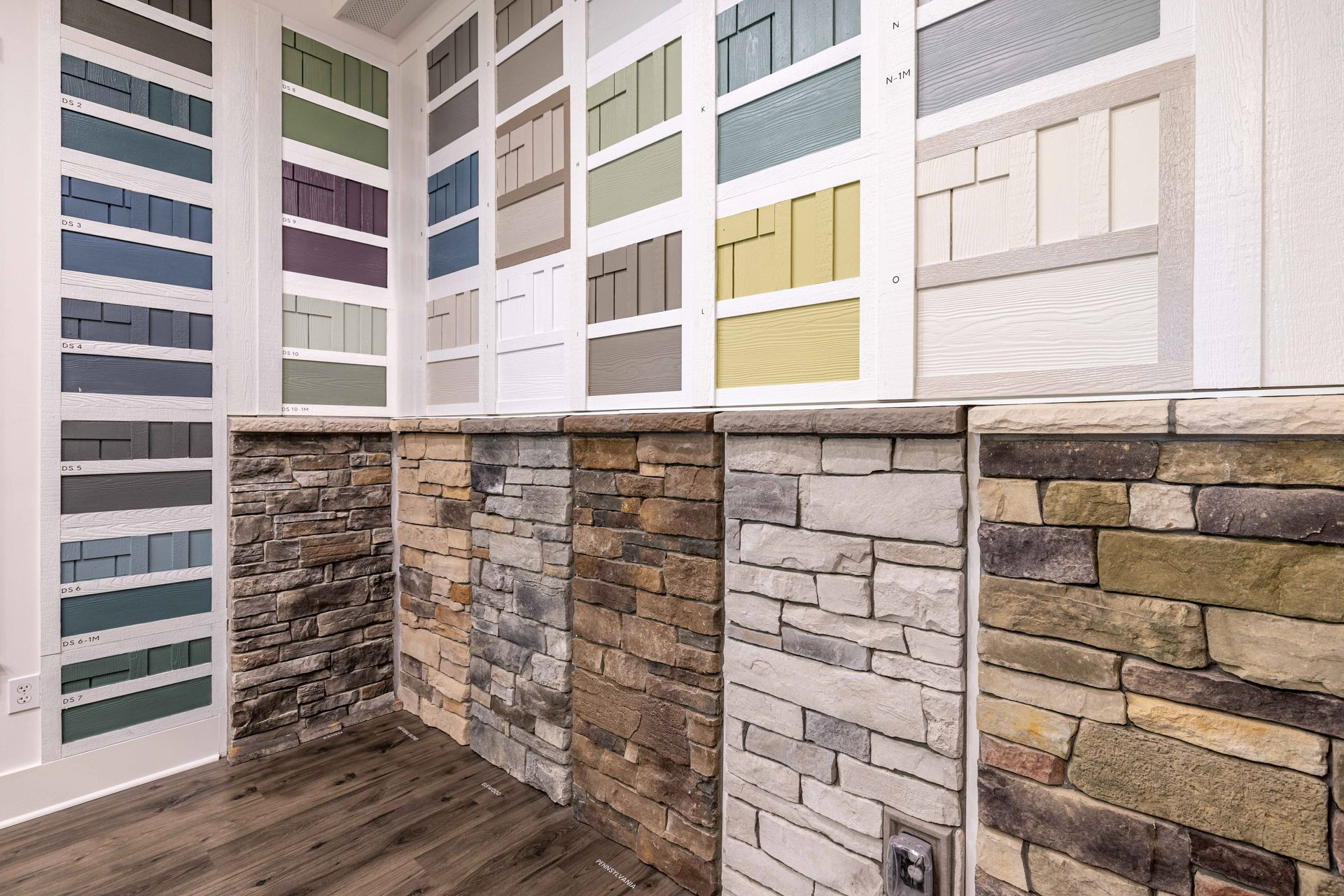 Samples of siding and stone veneer in a design showroom.