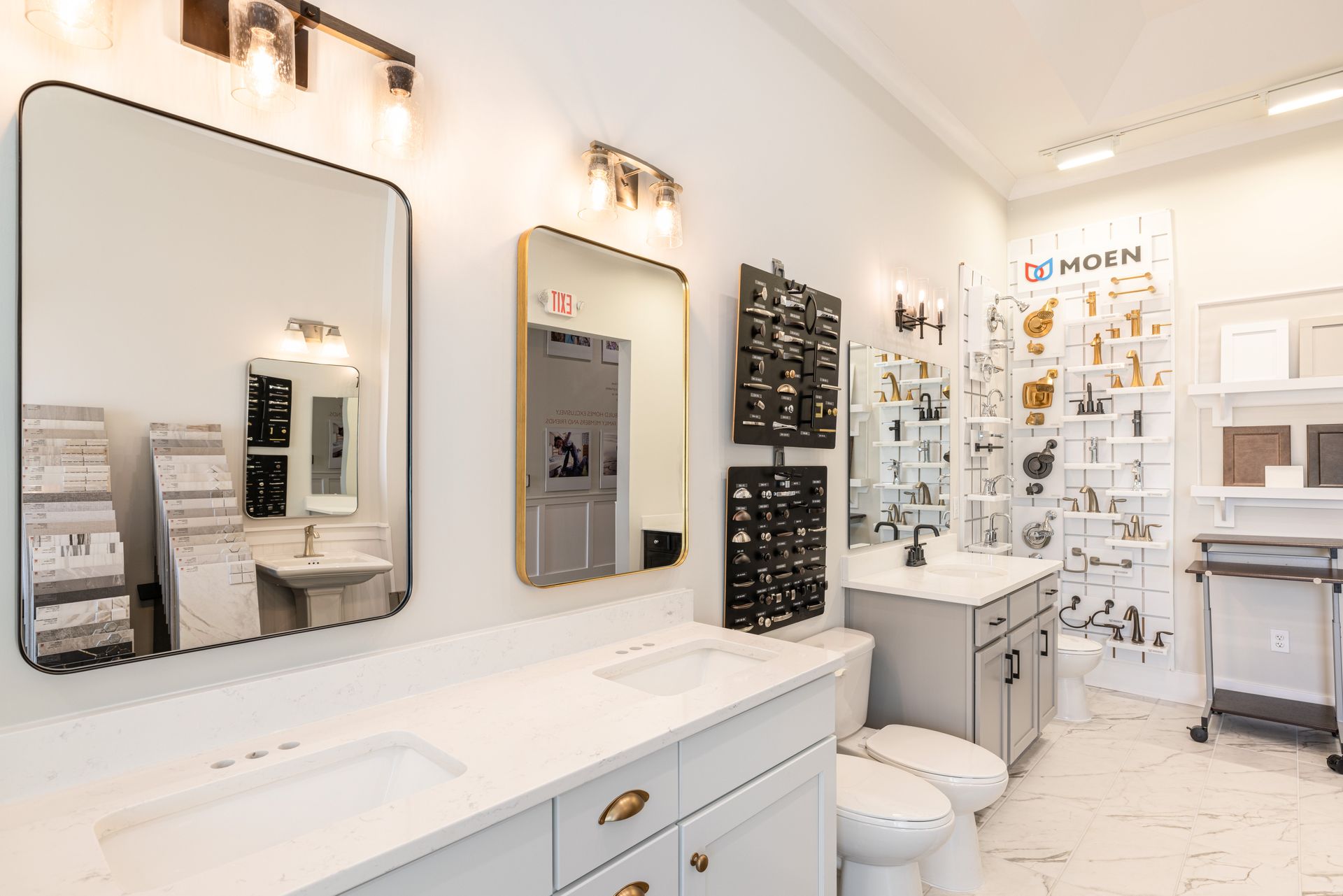A bathroom with a sink , toilet , and mirrors.