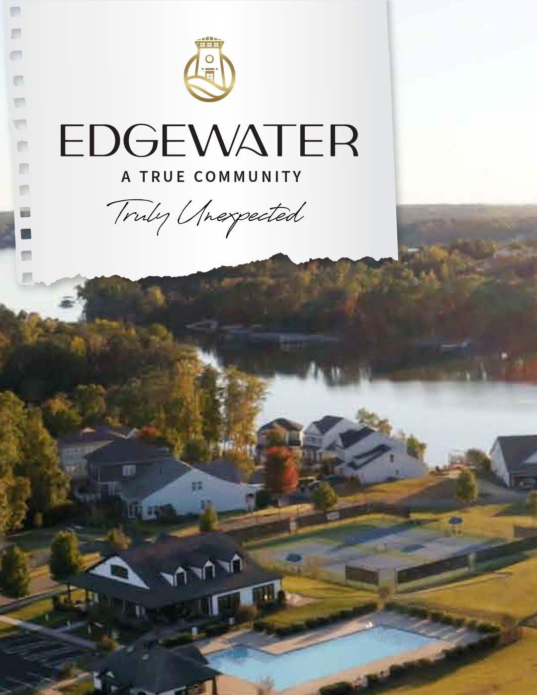 Aerial view of Edgewater community by a lake with houses, trees, and a pool.