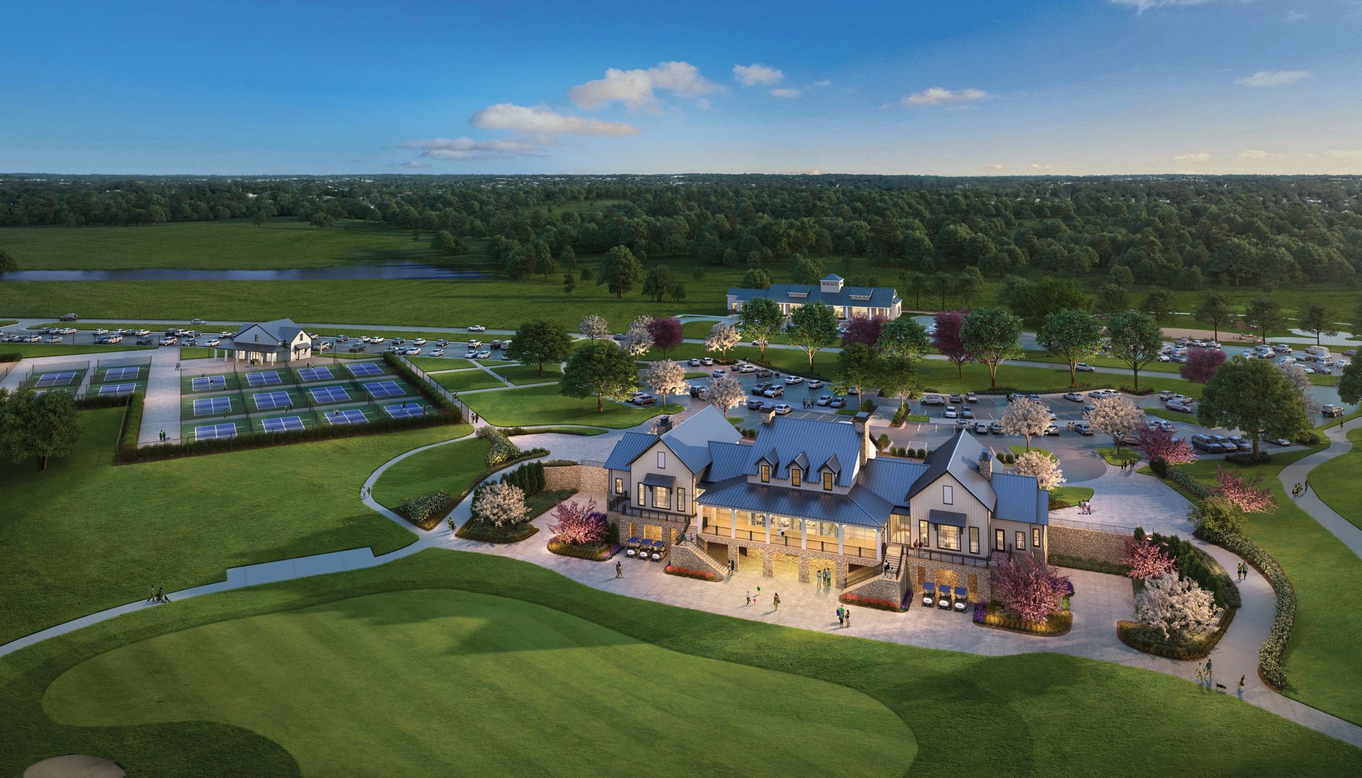 Golf course complex with a large stone clubhouse, trees, and a green lawn.