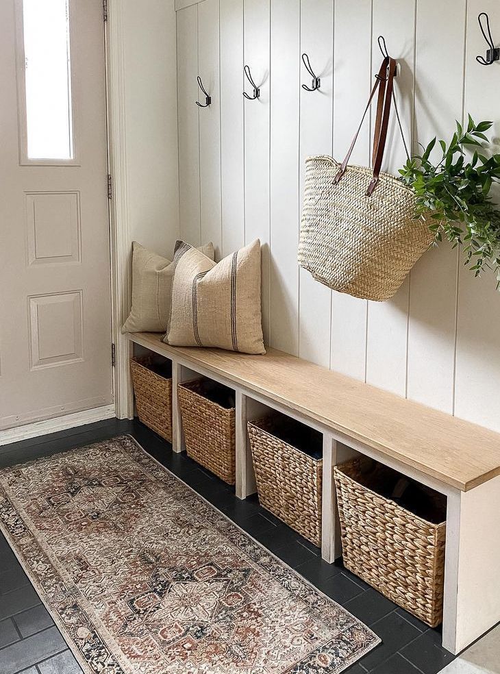 A hallway with a bench and baskets in it.