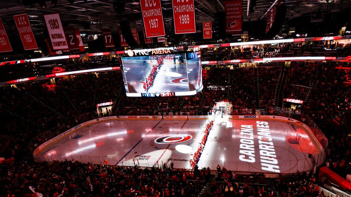 A hockey game is being played in a large stadium