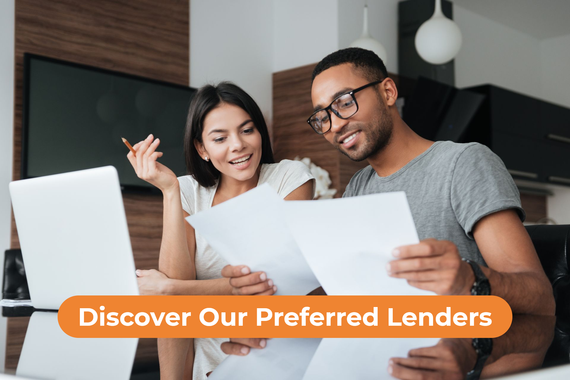 Two people reviewing documents at a laptop with “Discover Our Preferred Lenders” banner.