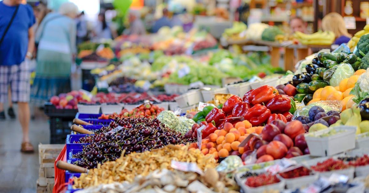 Produce market display with colorful produce, shoppers browsing.
