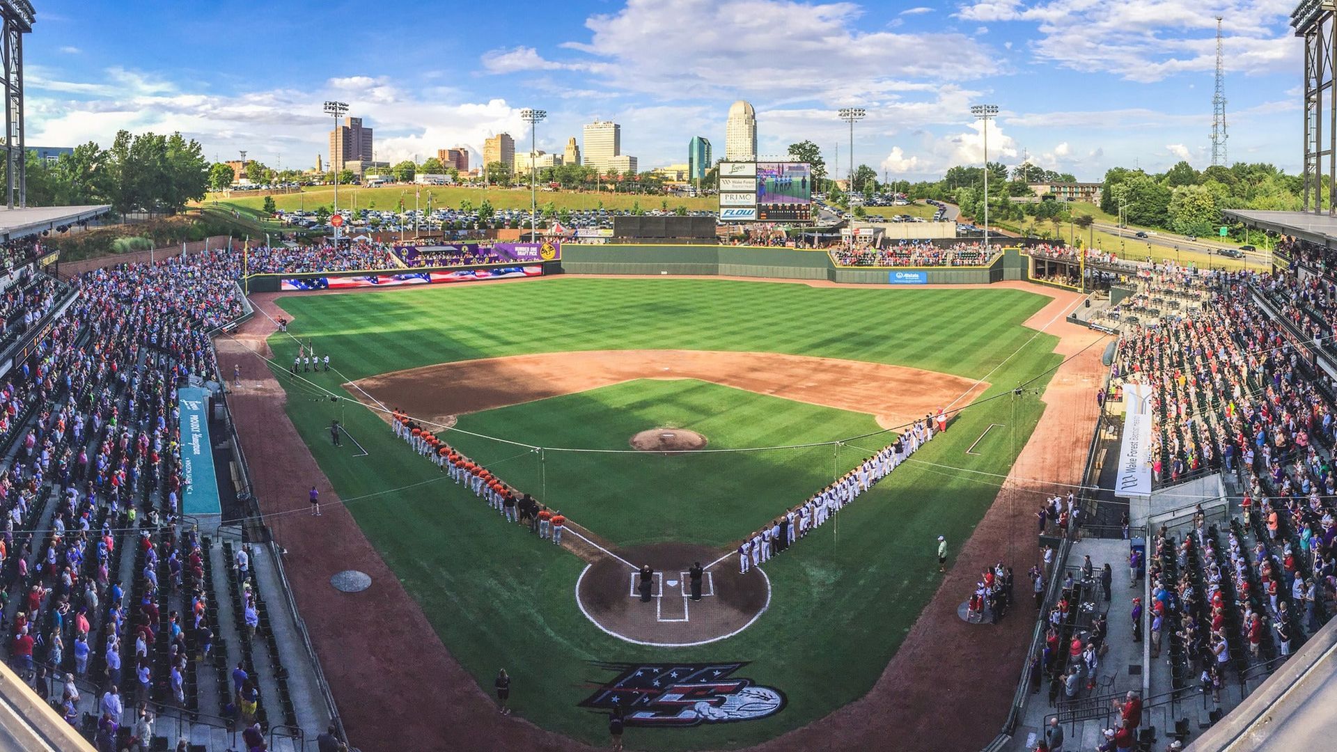 A baseball stadium filled with people watching a game