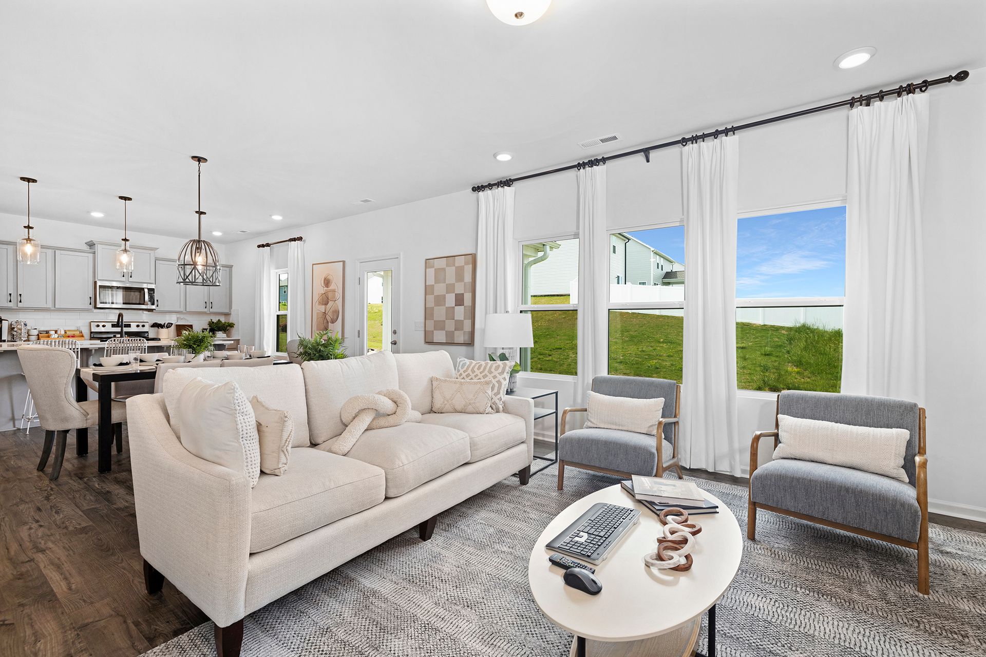 A living room with a couch , chairs , and a coffee table.
