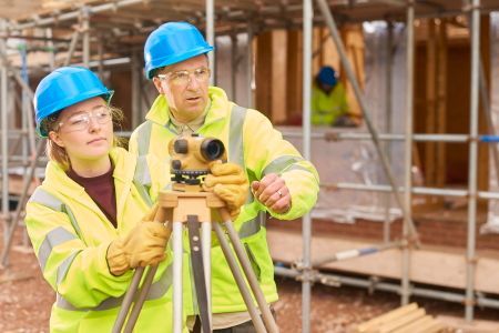 A man and a woman are working on a construction site.