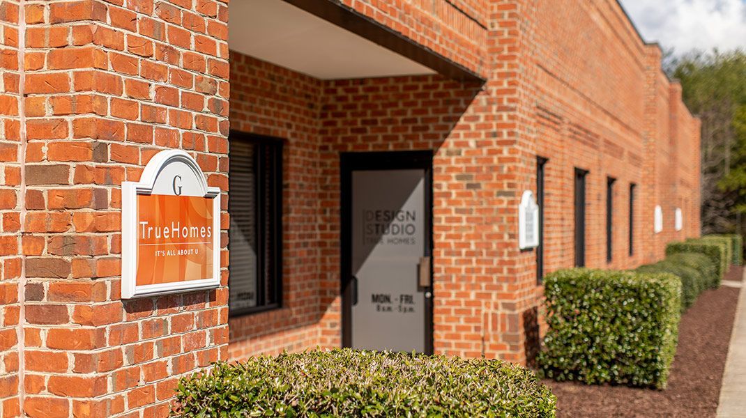 A brick building with a sign on the side of it and a door.