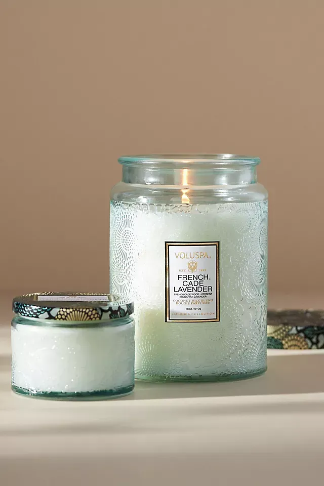 Two candles are sitting next to each other on a table.