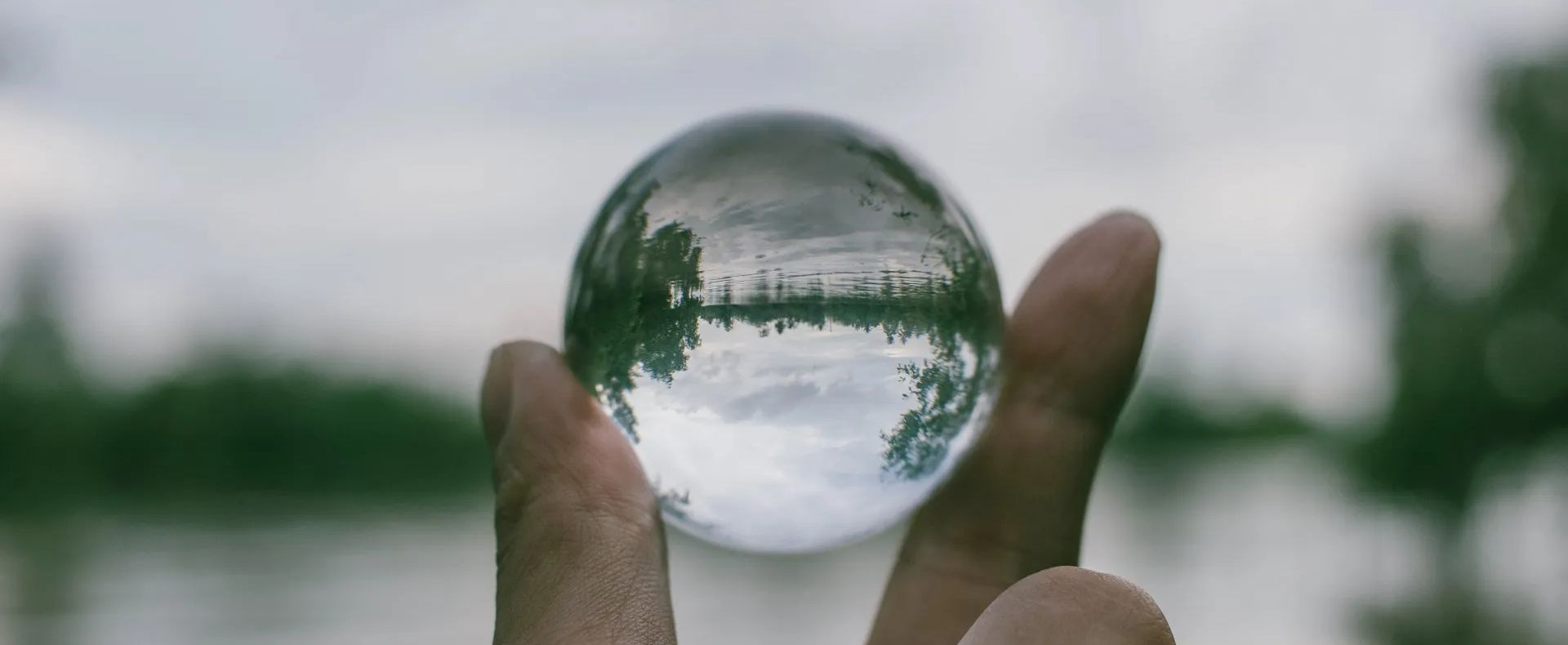 a hand holding a transparent glass to show the importance and need of transparency in an HOA - Empower HOA Web and Software Solutions