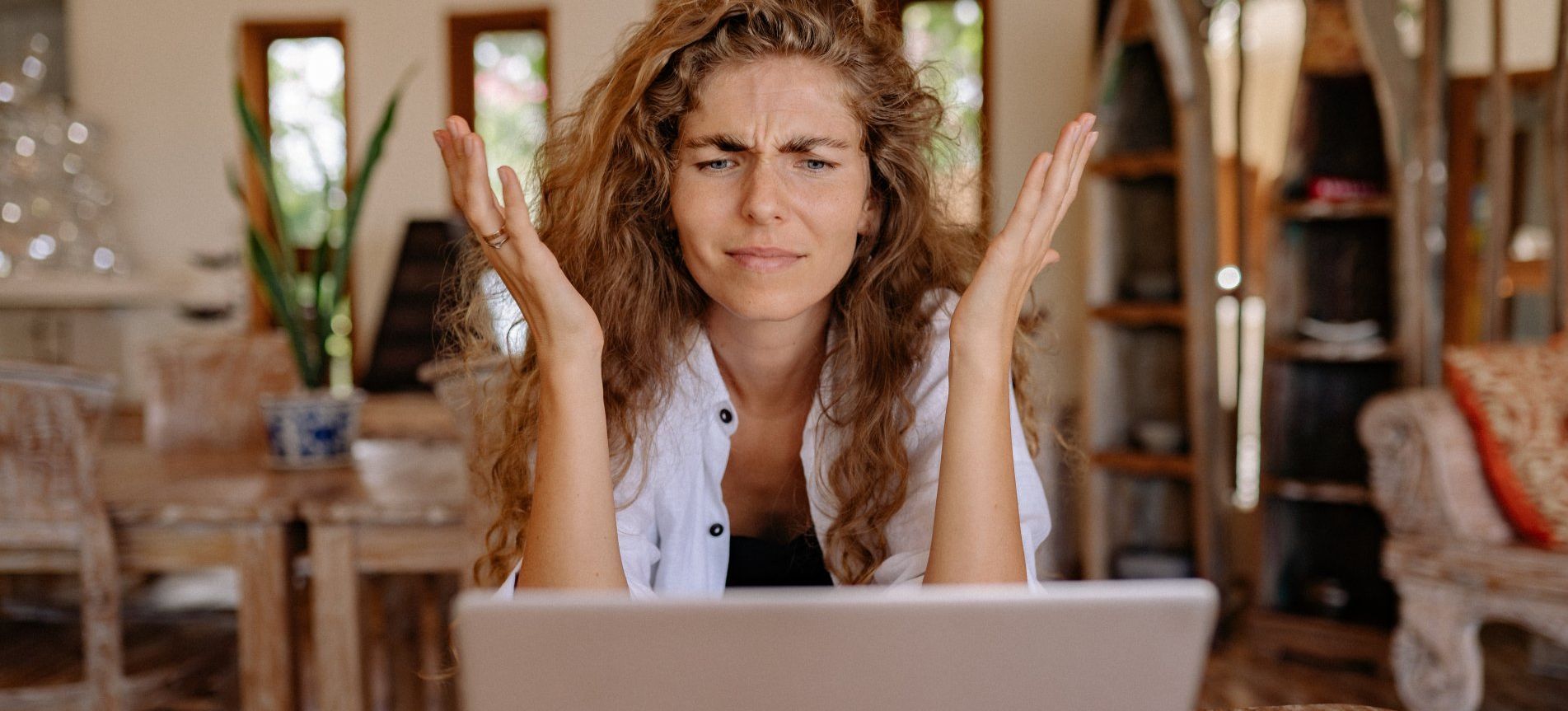 A frustrated HOA Community Manager looking at her computer screen - Empower HOA Web and Software Solutions