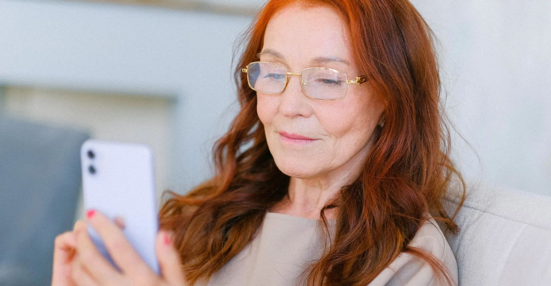 A women holding a smart phone showing information from the HOA directly via SMS, email, or web - Empower HOA Web and Software Solutions