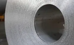 A close up of a metal coil with a hole in the middle.