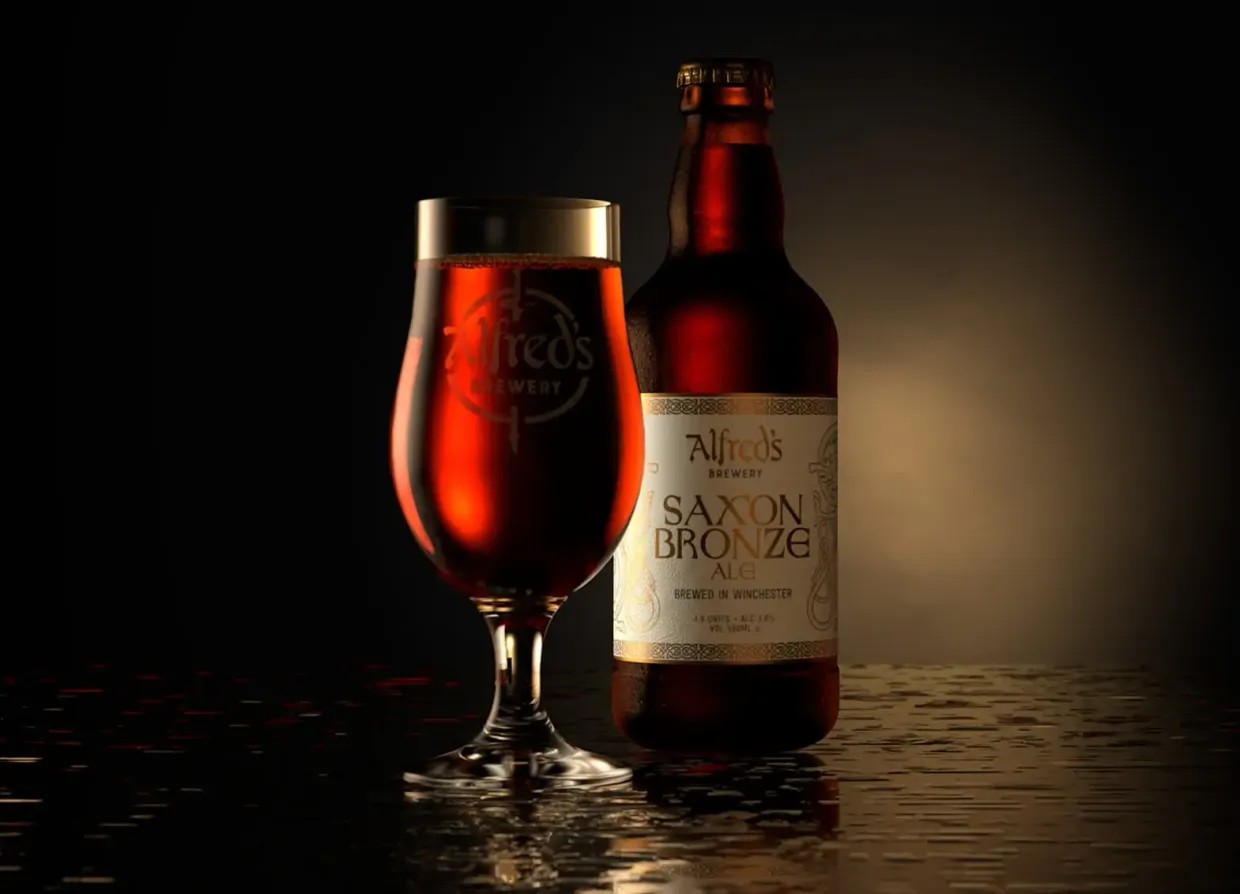 A bottle of saxon bronze next to a glass