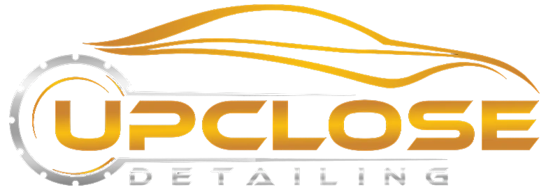 a logo for upclose detailing with a car on it .
