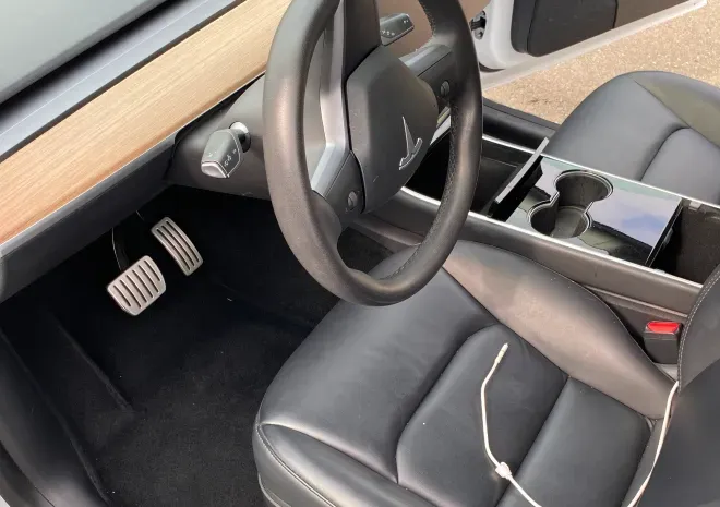 the interior of a tesla model 3 with a steering wheel