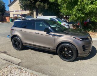 a range rover evoque is parked on the side of the road .