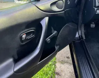 a close up of a car door with the door open .