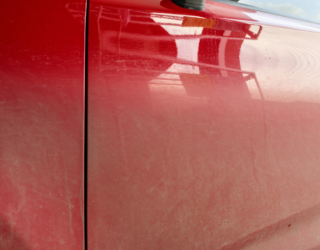 a close up of the side of a red car