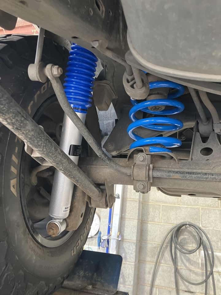 Blue Shock Absorber and Spring Installed on a Vehicle's Rear Suspension — TJM Albury Pty Ltd in South Albury, NSW