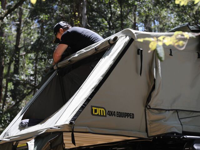 A Man is Sitting in a Tent That Says TJM 4x4 Equipped — TJM Albury Pty Ltd in South Albury, NSW