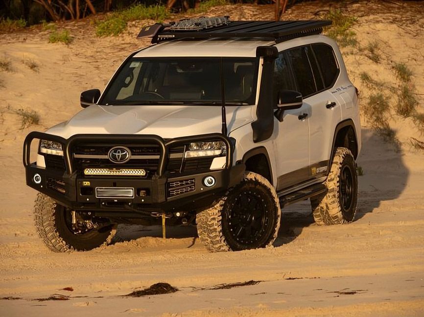 A White Toyota Land Cruiser is Driving on a Sandy Beach — TJM Albury Pty Ltd in South Albury, NSW