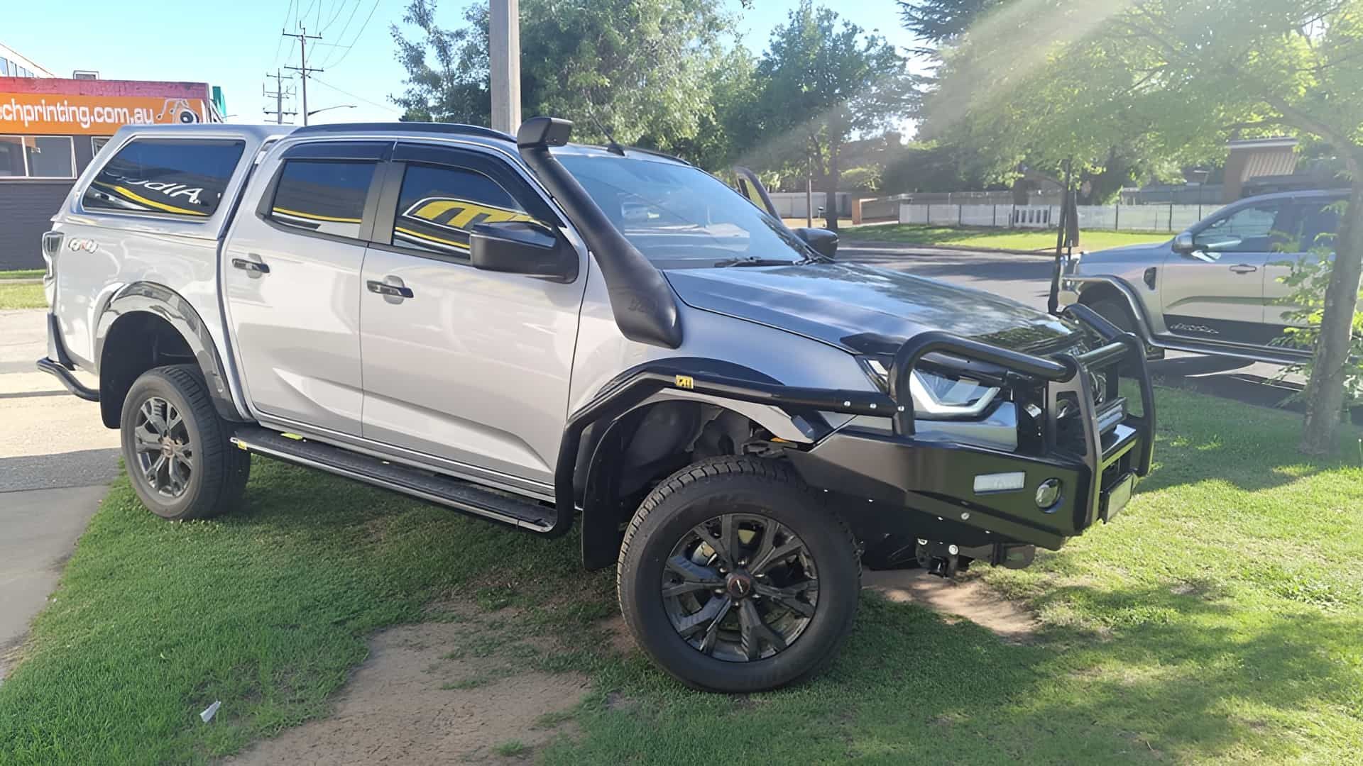 Silver Pickup Truck With Black Accessories Parked on Grass — TJM Albury Pty Ltd in South Albury, NSW