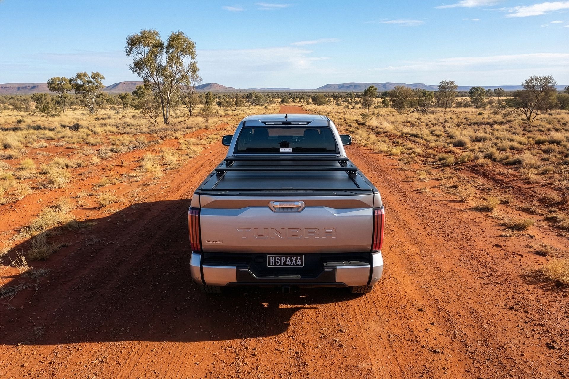 A Blue Truck With the Trunk Open is Parked in the Dirt — TJM Albury Pty Ltd in South Albury, NSW