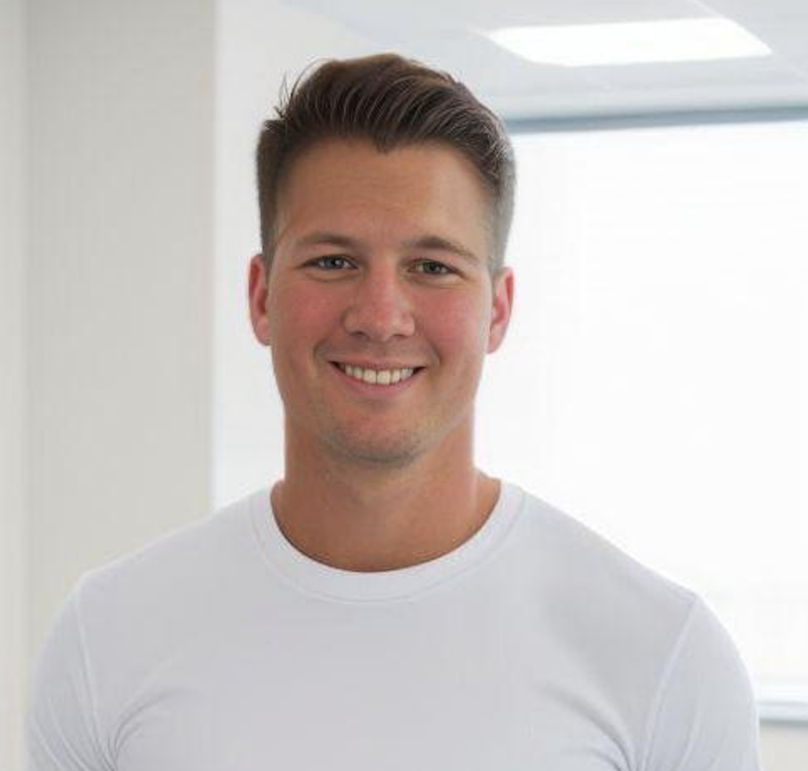 A man in a white shirt is smiling for the camera.