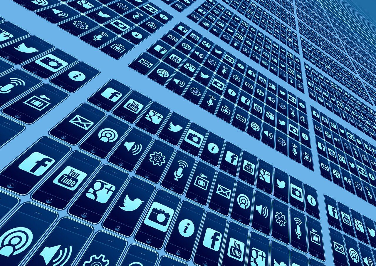 A bunch of phones with social media icons on them