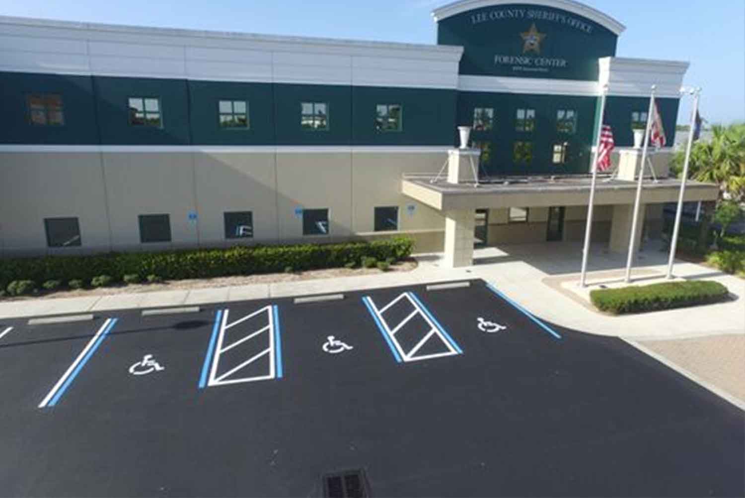 An aerial view of a parking lot in front of a large building.