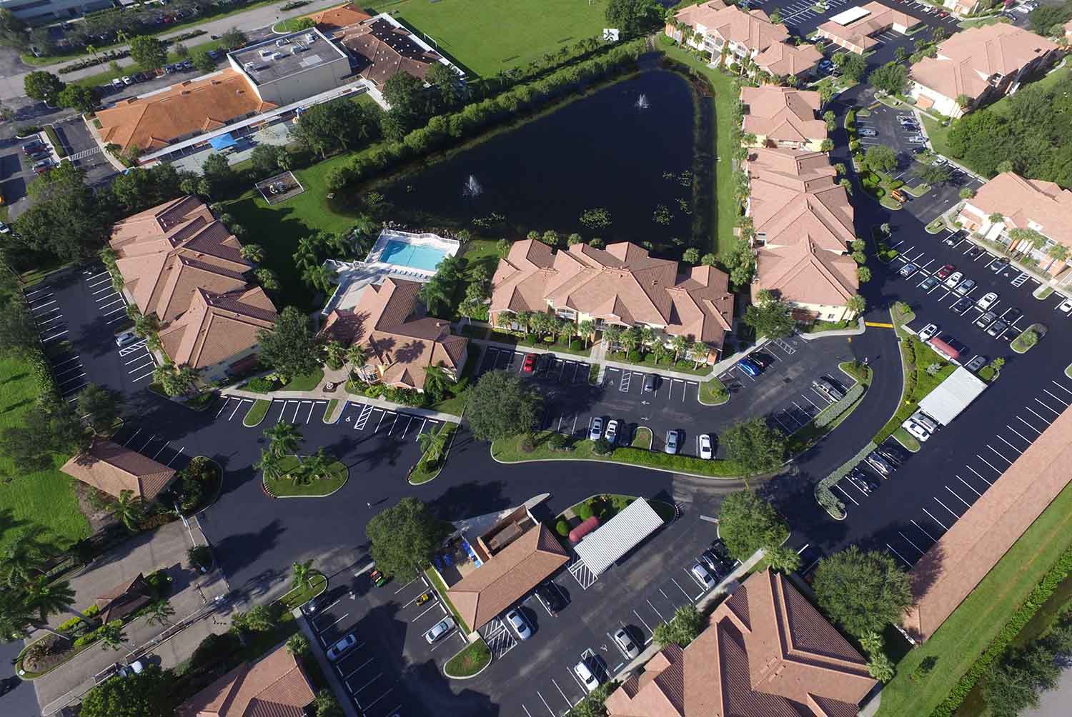 An aerial view of a residential area with a lake in the middle