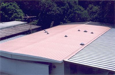 A red roof with a few screws on it