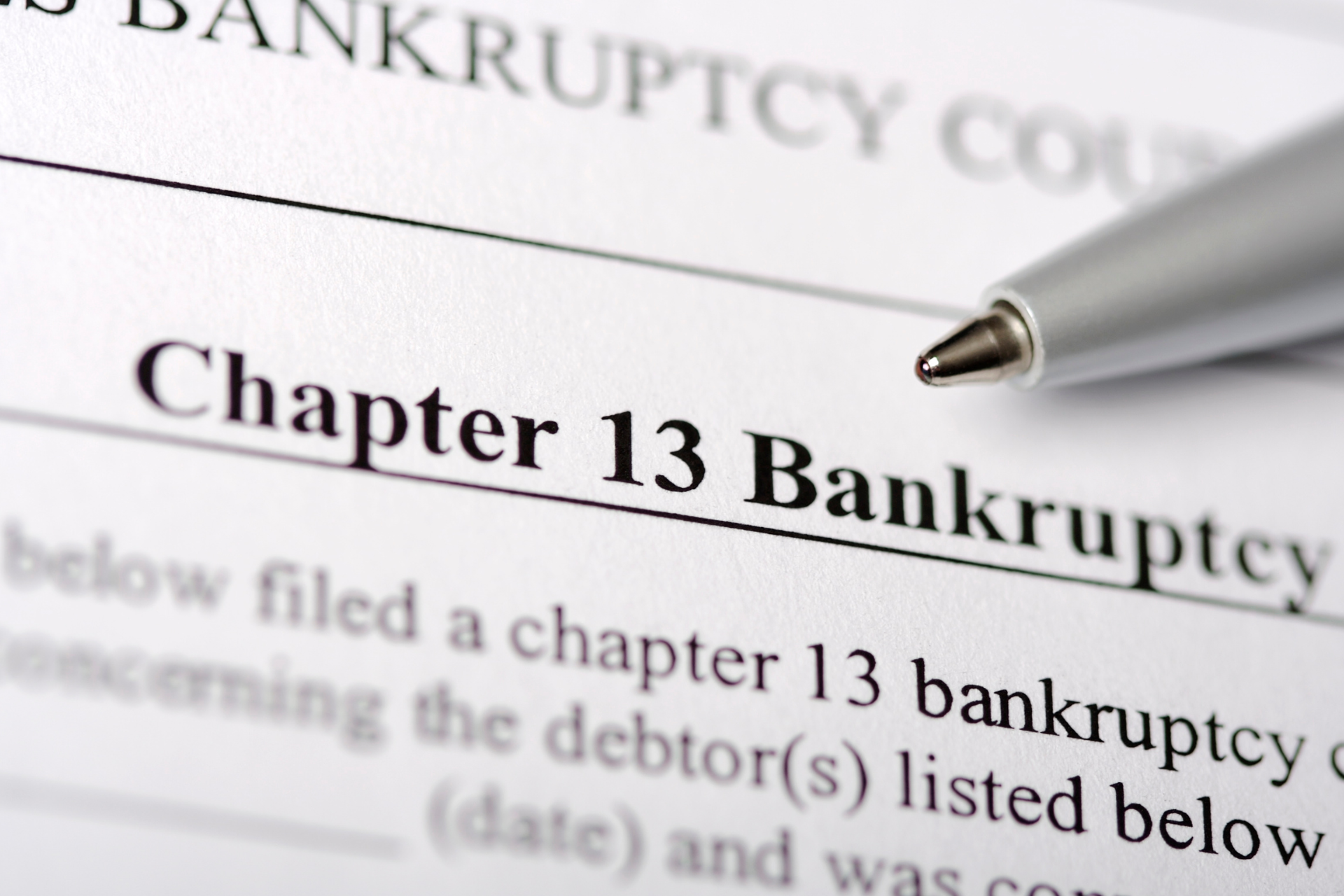 “Chapter 13 Bankruptcy” form with a pen on it