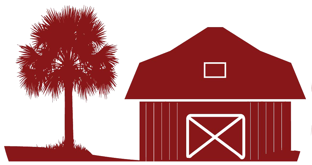 A red barn with a tree in front of it.