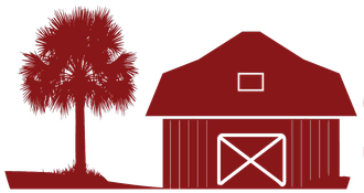A red barn with a tree in front of it.