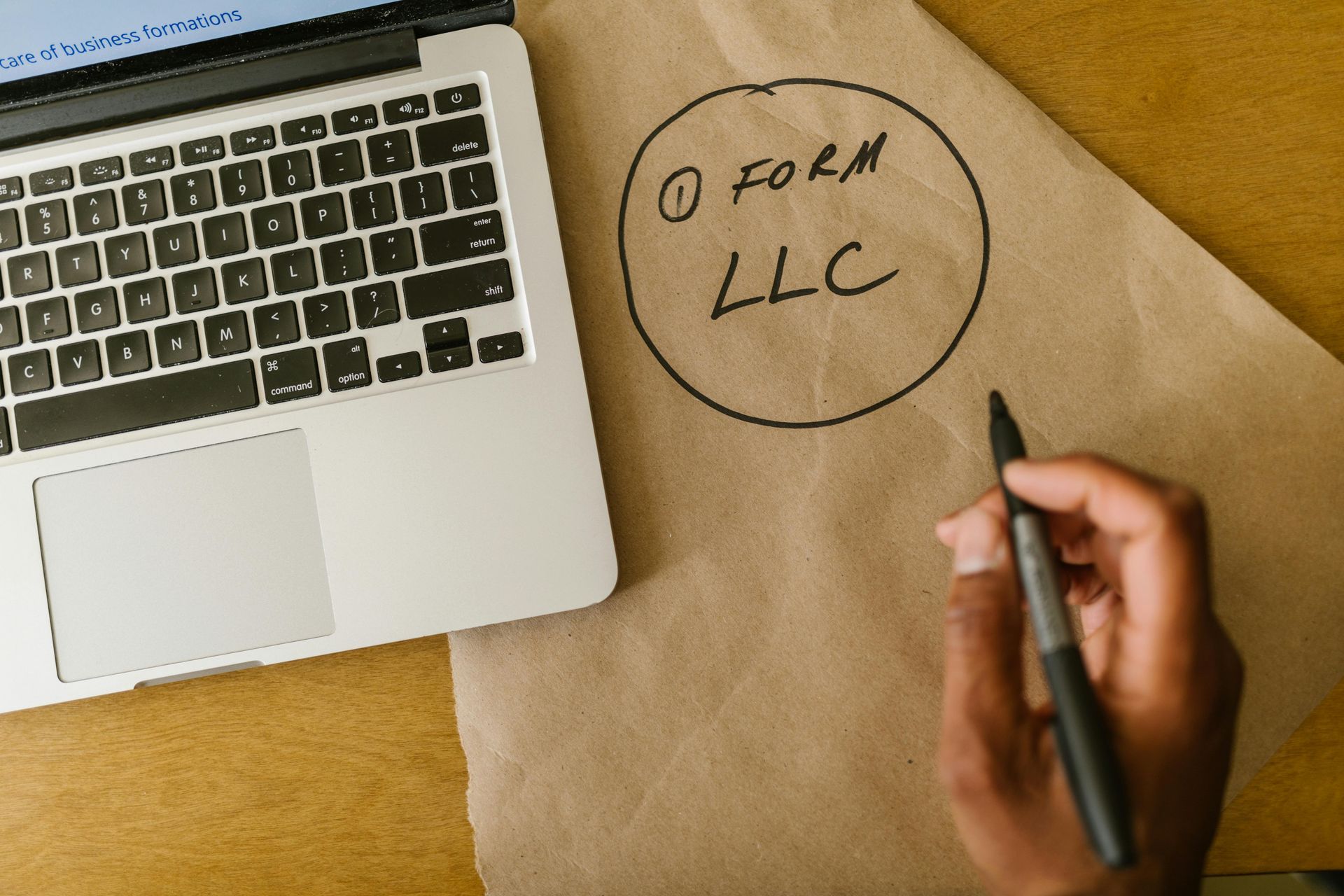 Business Owner Holding Marker and Working on Laptop