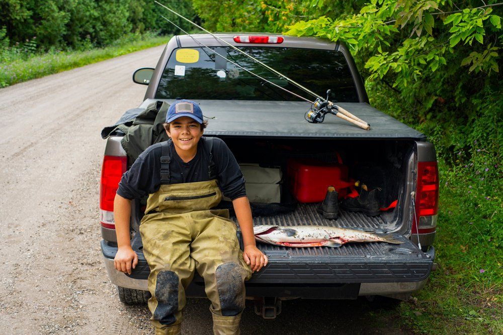 Young Fisherman With His Pick Up Truck — Ogden, UT — Sam T Evans Pickup Cover & Trailer Sales Young Fisherman With His Pick Up Truck — Ogden, UT — Sam T Evans Pickup Cover & Trailer Sales