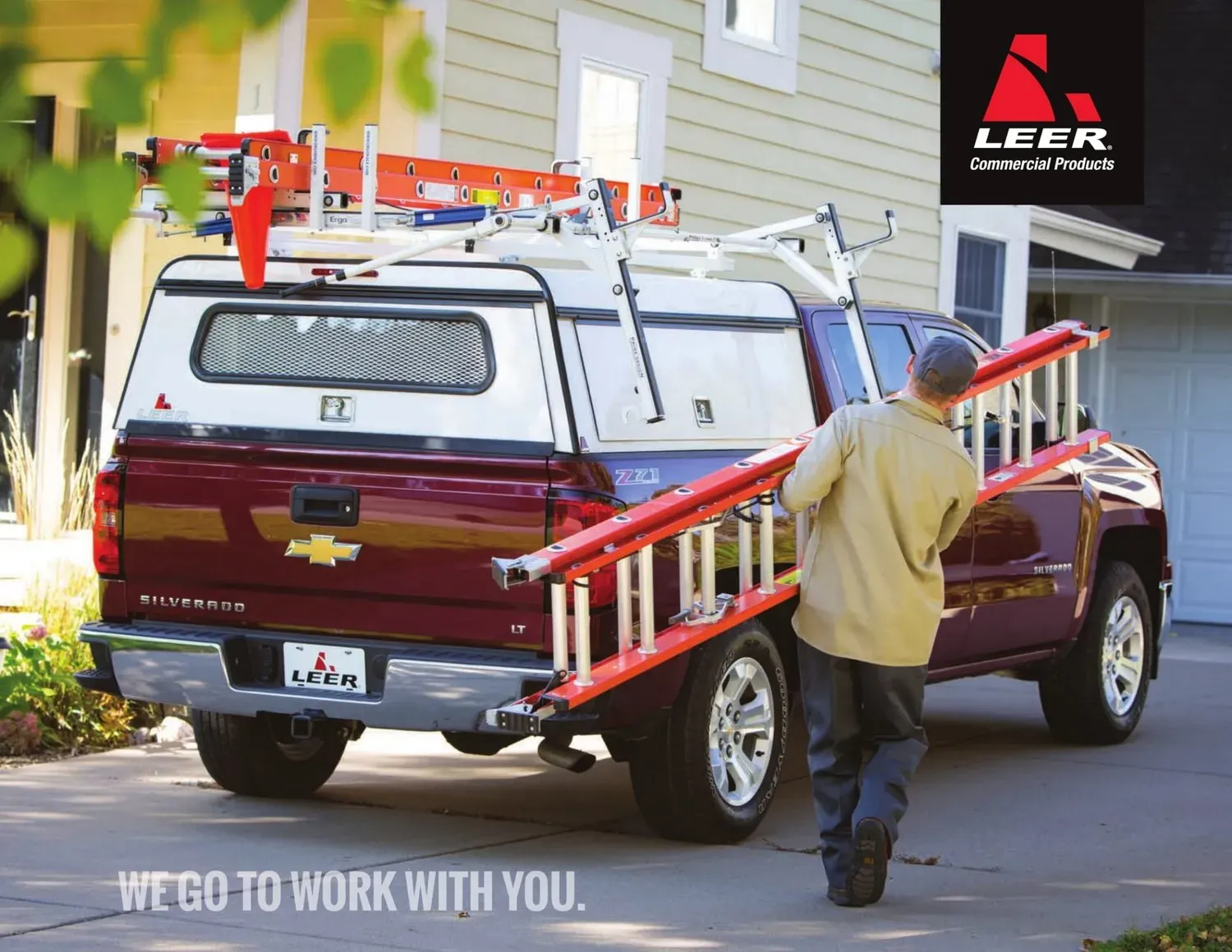 Man With Ladder Beside Pick Up Truck — Ogden, UT — Sam T Evans Pickup Cover & Trailer Sales