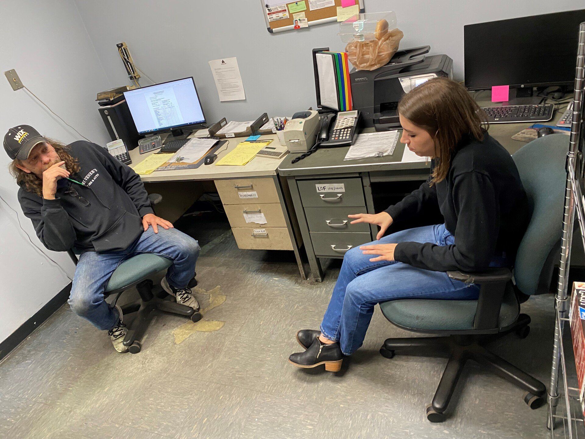 Man And Woman Sitting Inside Office — Chester, VA — Heveners Tire & Auto