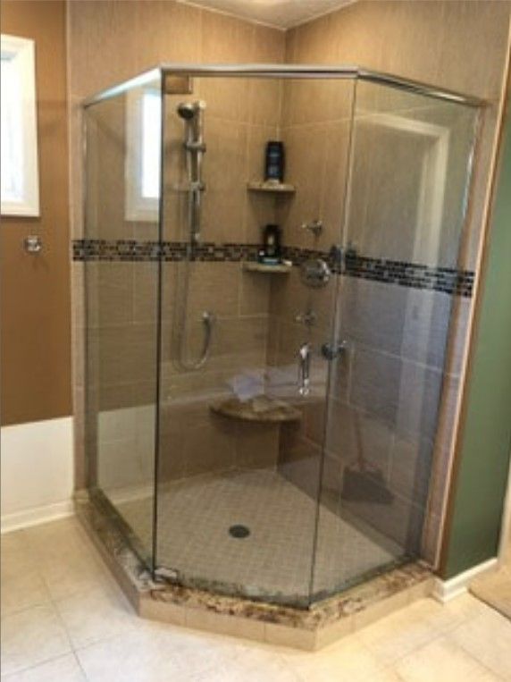 A bathroom with a walk-in shower and a bathtub.